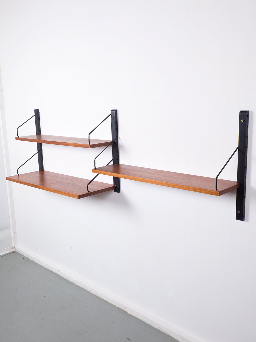 Modulaire wandkast, Royal system, geproduceerd door Cado in de jaren 50. Dit teak houten systeem heeft 3 planken met 3 rails